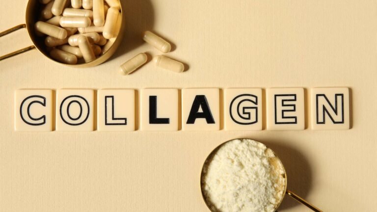 The picture shows a beige background with scrabble letters spelling collagen, and 2 gold scoops. 1 filled with capsules, and the other with white powder
